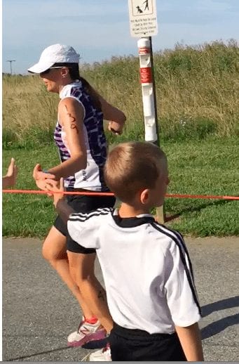 a woman running giving a kid a high five